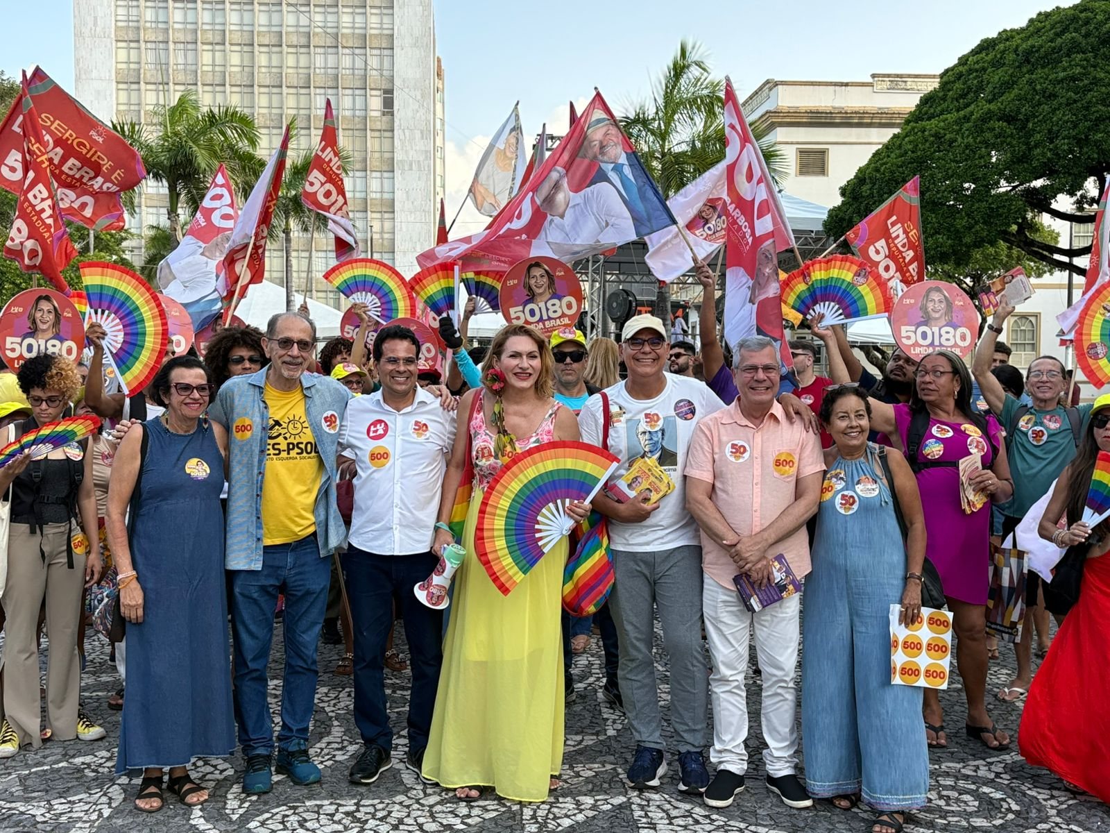 Candidatos e apoiadores do Psol reunidos com bandeiras e leques coloridos durante caminhada no Centro de Aracaju
